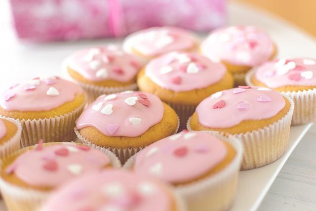 Cupcakes with pink icing and small sugar heart decorations